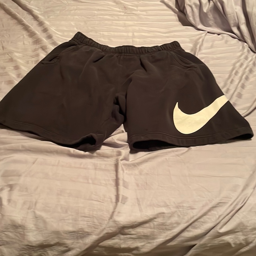 Black Nike large sweat shorts with swoosh on side.